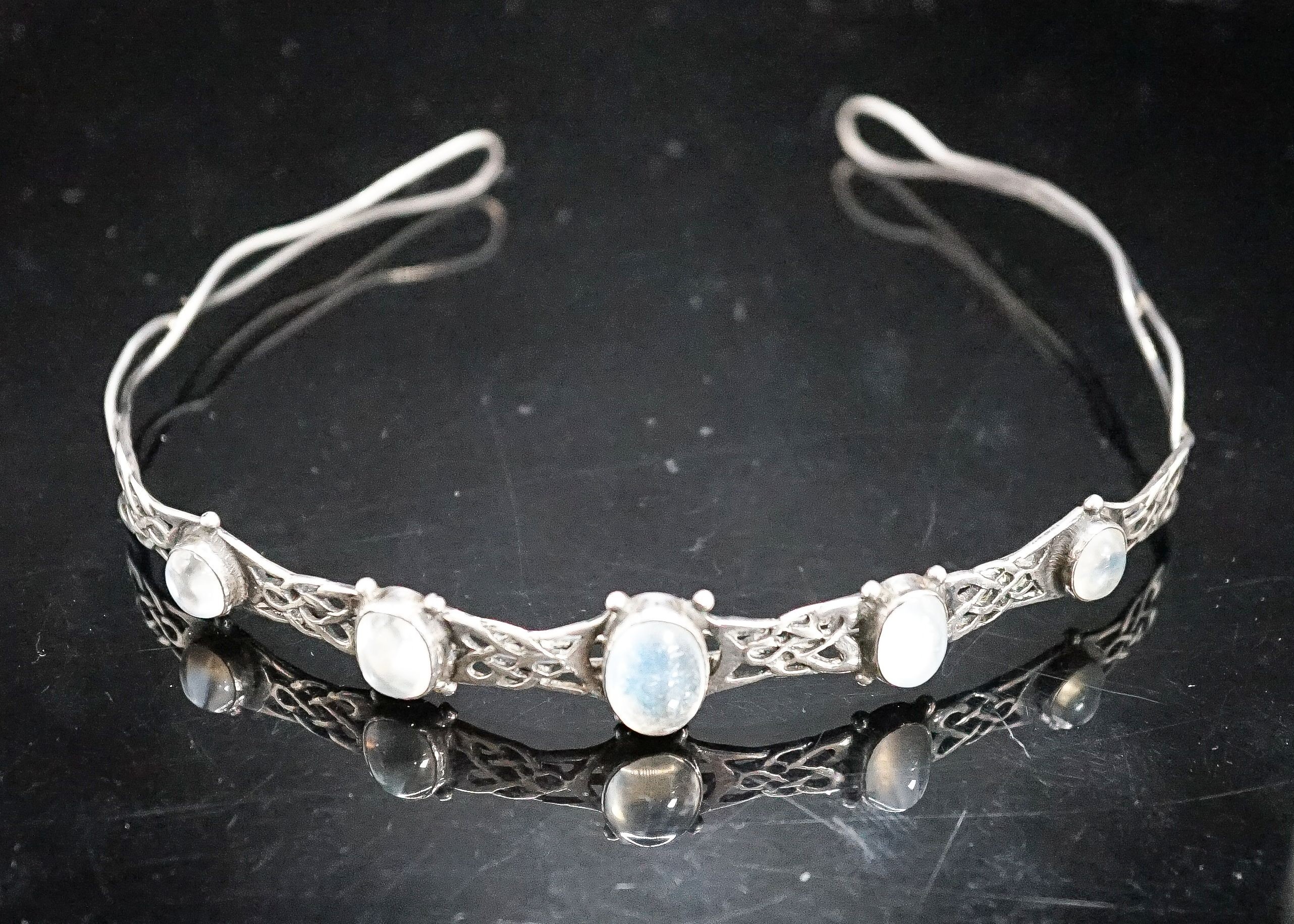 A white metal and graduated five stone cabochon moonstone set tiara, diameter 12.5cm